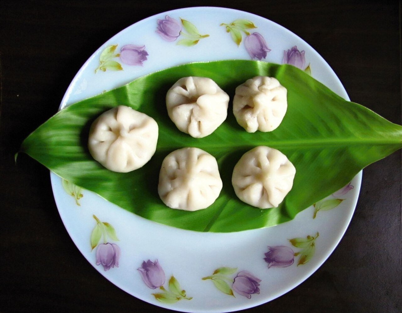 Traditional modak served on a banana leaf